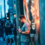 Man using a smartphone on the street.